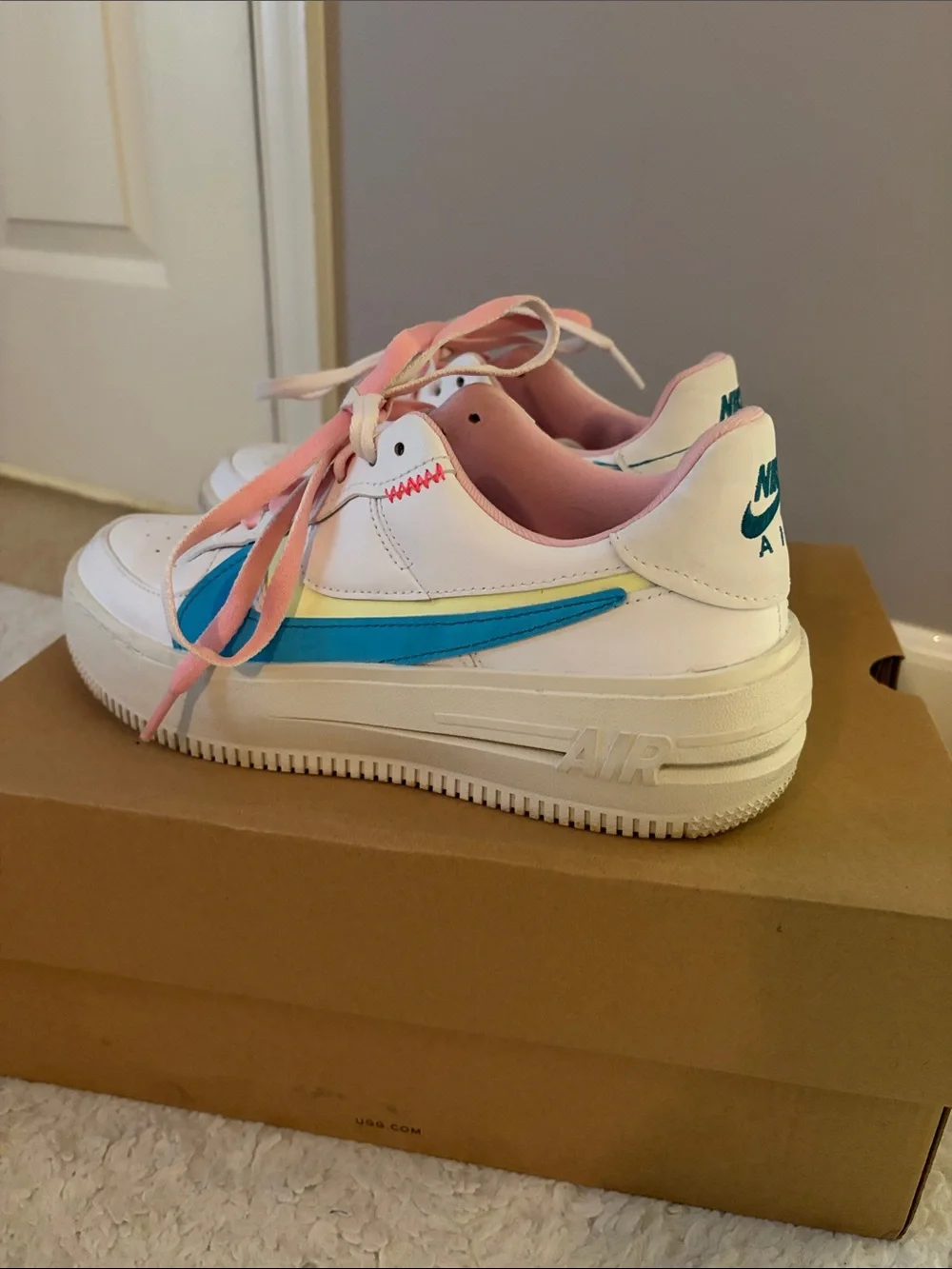 Nike Woman’s White Sneakers with Blue Swoosh and Pink Laces